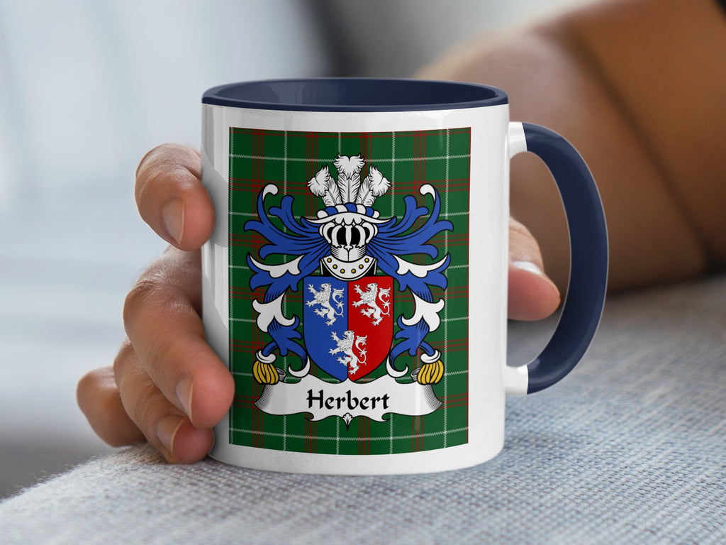 White mug with navy handle, featuring the Herbert family crest on a green tartan background.