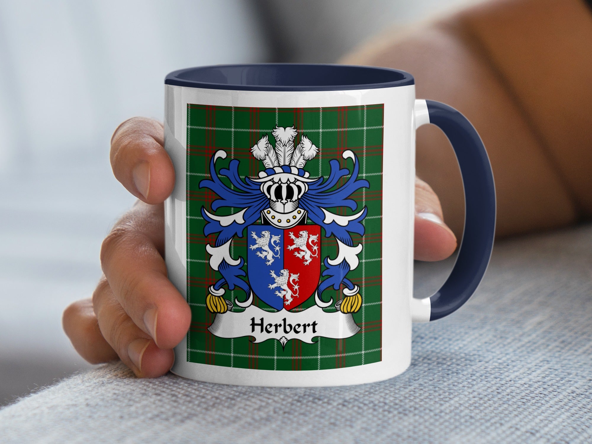 White mug with navy handle, featuring the Herbert family crest on a green tartan background.