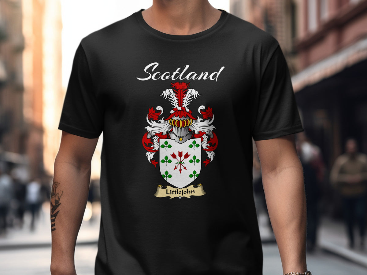 Model wearing a black Littlejohn T-shirt featuring green clover motifs and red diamond details