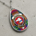Belshes clan Scottish tartan necklace with crest design and Latin motto on tartan background