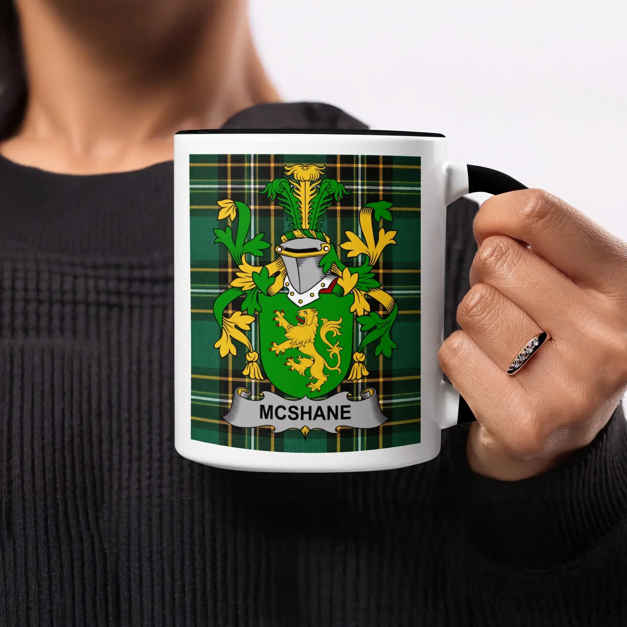 Mug with McShane family crest on tartan background.