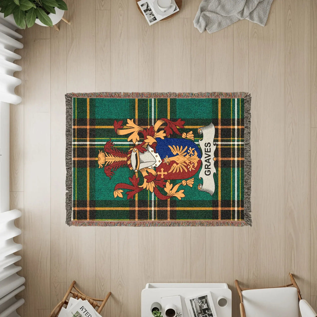 Green tartan blanket with Graves clan crest, laid on a wooden floor.