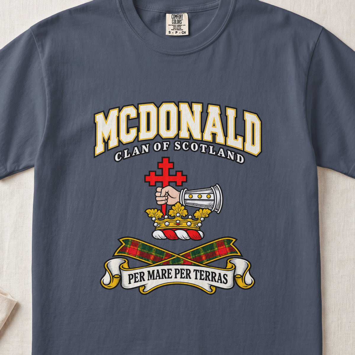 McDonald graphic T-shirt in Midnight blue, front flat lay showing varsity lettering and armoured forearm with hand holding red cross.