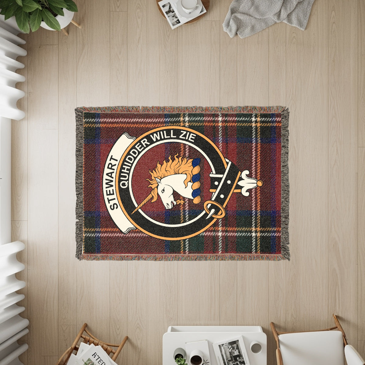 Stewart of Appin woven blanket displayed on a wall, featuring the crest badge and tartan background