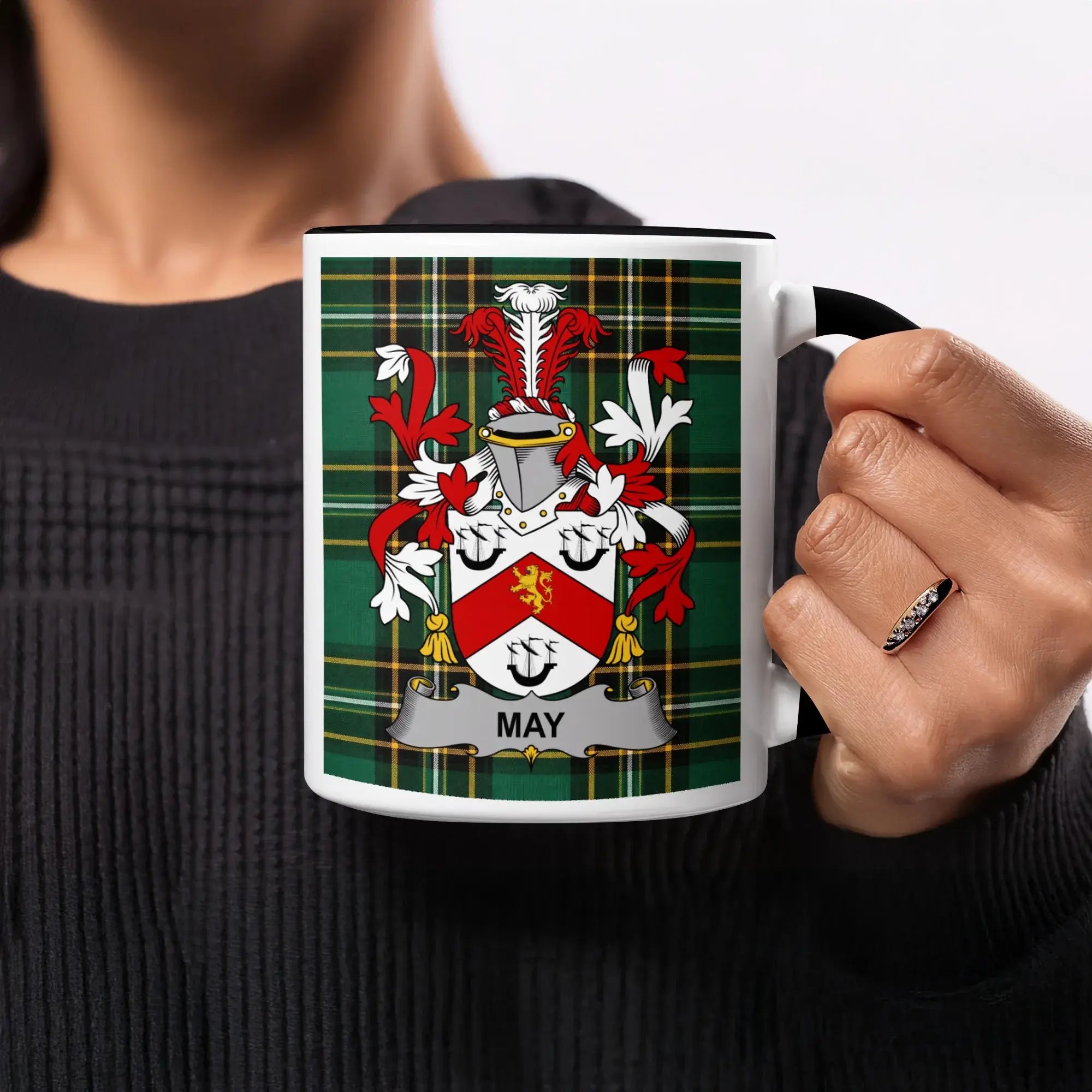Mug with May family crest on green plaid background.