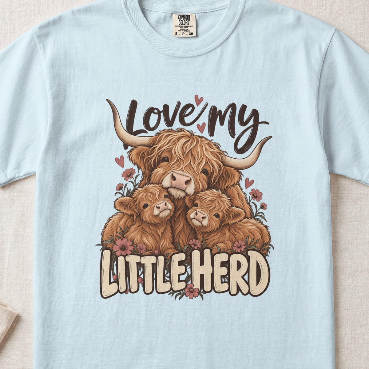 Love My Little Herd Highland cow design on a Chambray Comfort Colors 1717 T-shirt, flat lay