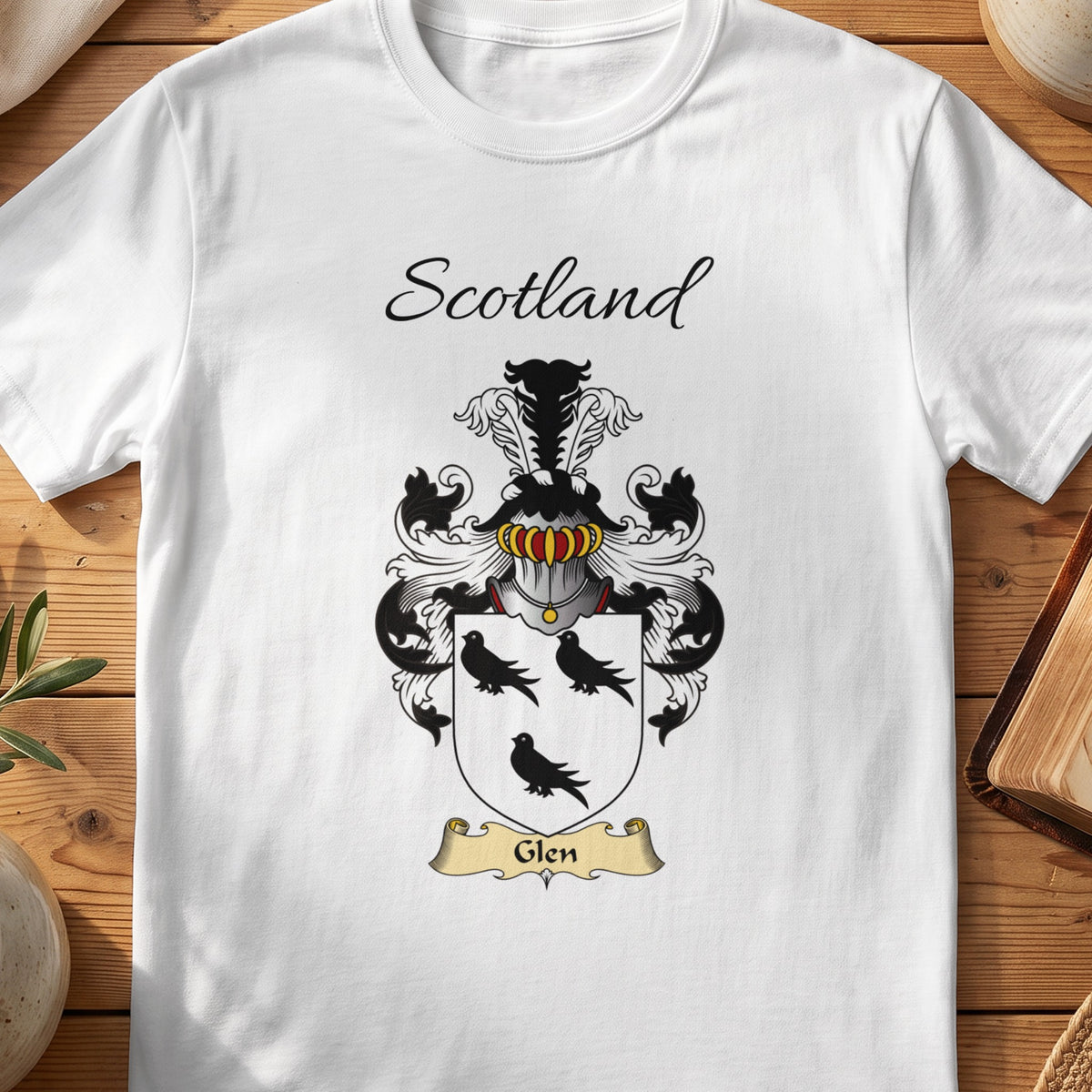 White Glen Scottish family shield T-shirt featuring three black birds on a white shield