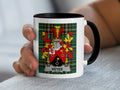 White mug with black rim displaying the Keyes family crest on a green tartan background.
