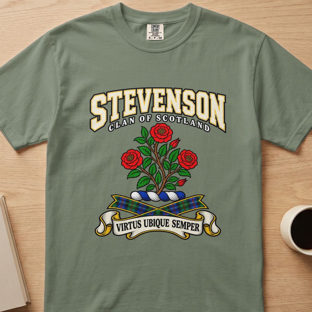 Stevenson three red roses and leafy stems graphic on a sage green Comfort Colors T-shirt, front view