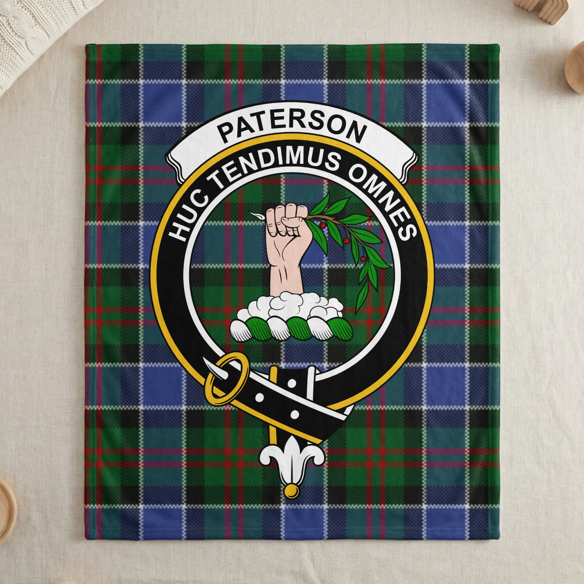 Paterson name banner and crest on tartan throw blanket — draped display