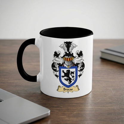 White mug with black handle featuring the Brocas family crest.