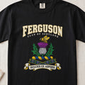 Ferguson graphic T-shirt in Black, front flat lay showing varsity lettering and yellow and black bee above a purple and white thistle.