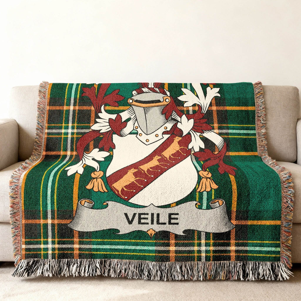 Green plaid woven throw blanket with a coat of arms and "VEILE" banner.