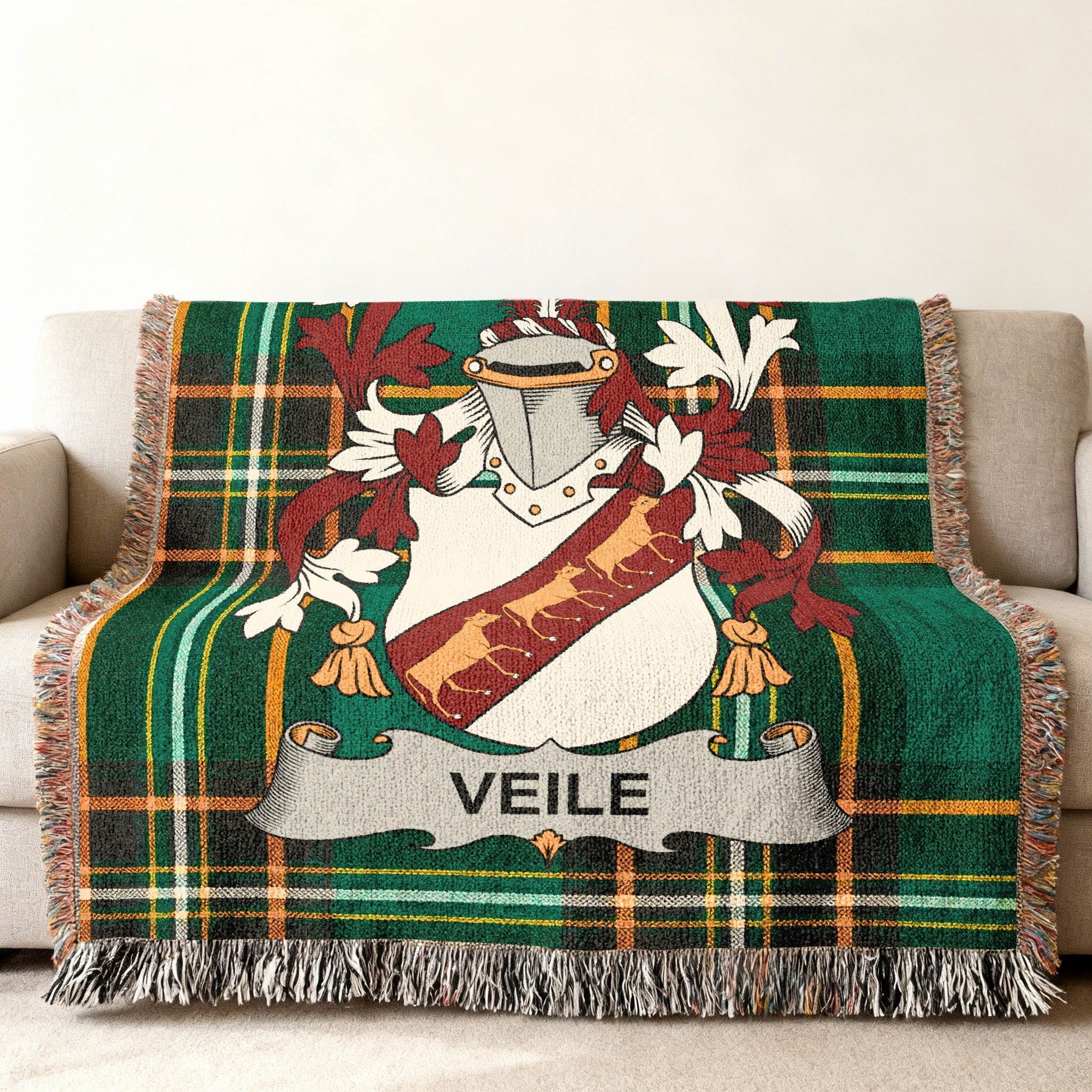 Green plaid woven throw blanket with a coat of arms and "VEILE" banner.