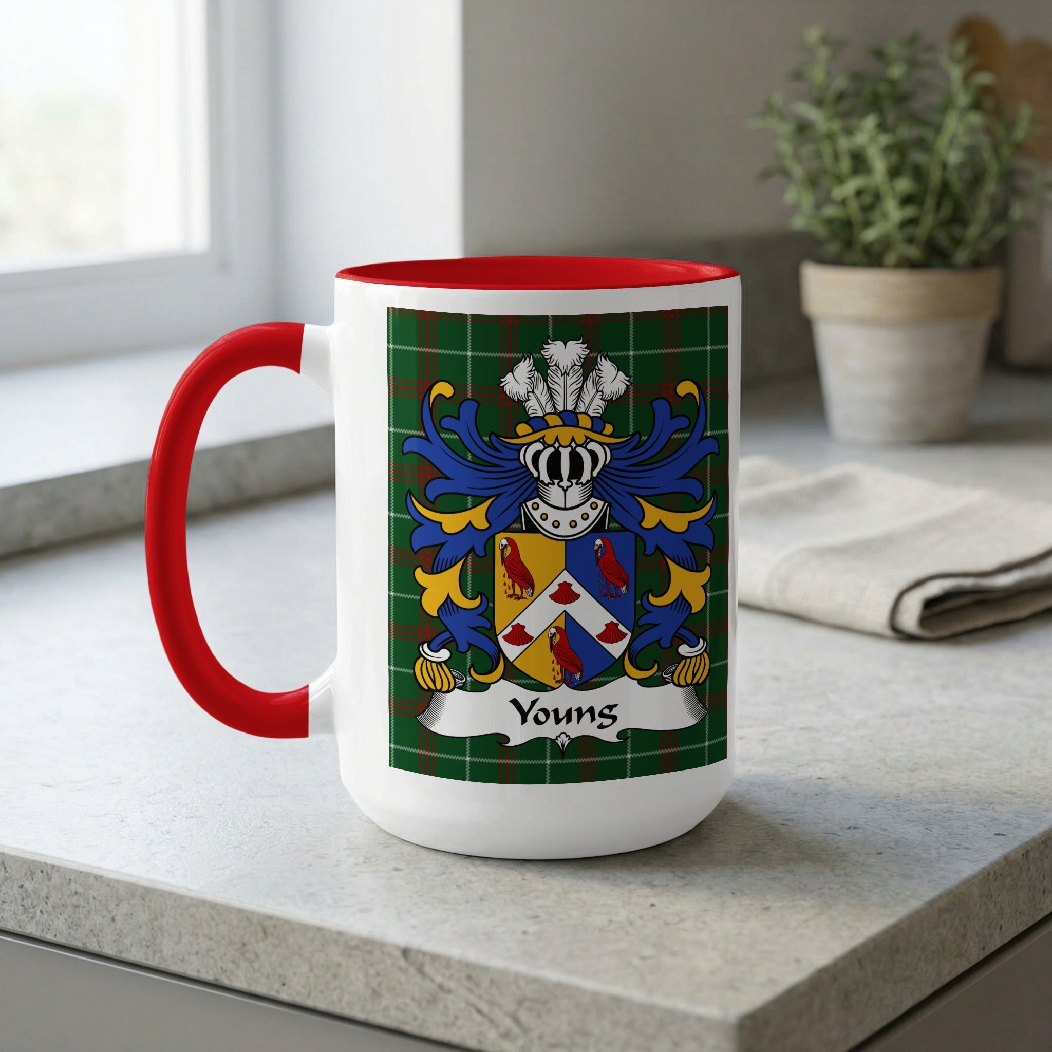 White mug with red handle and rim featuring the Youngs family crest.
