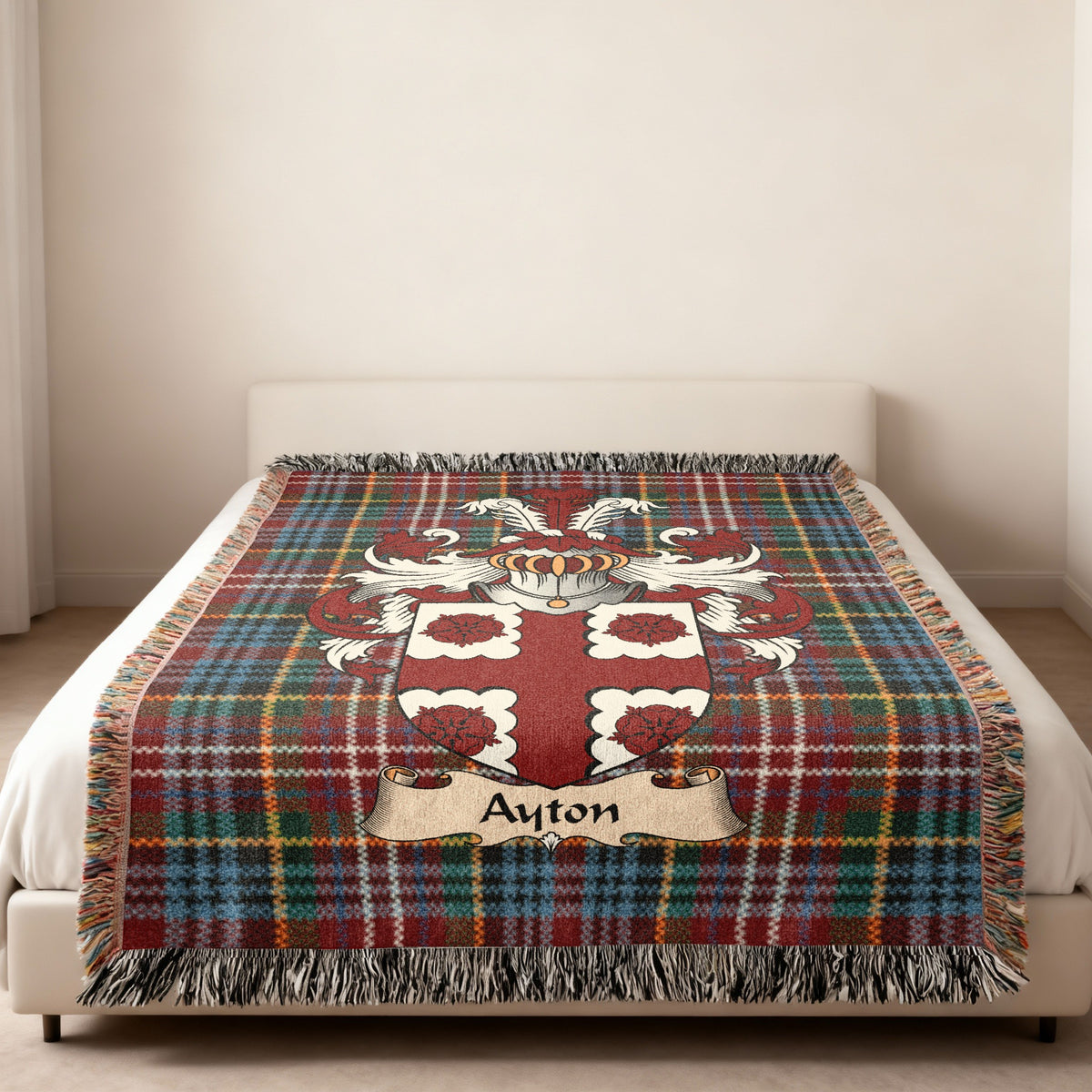 Ayton family crest emblem on a Caledonia tartan woven blanket