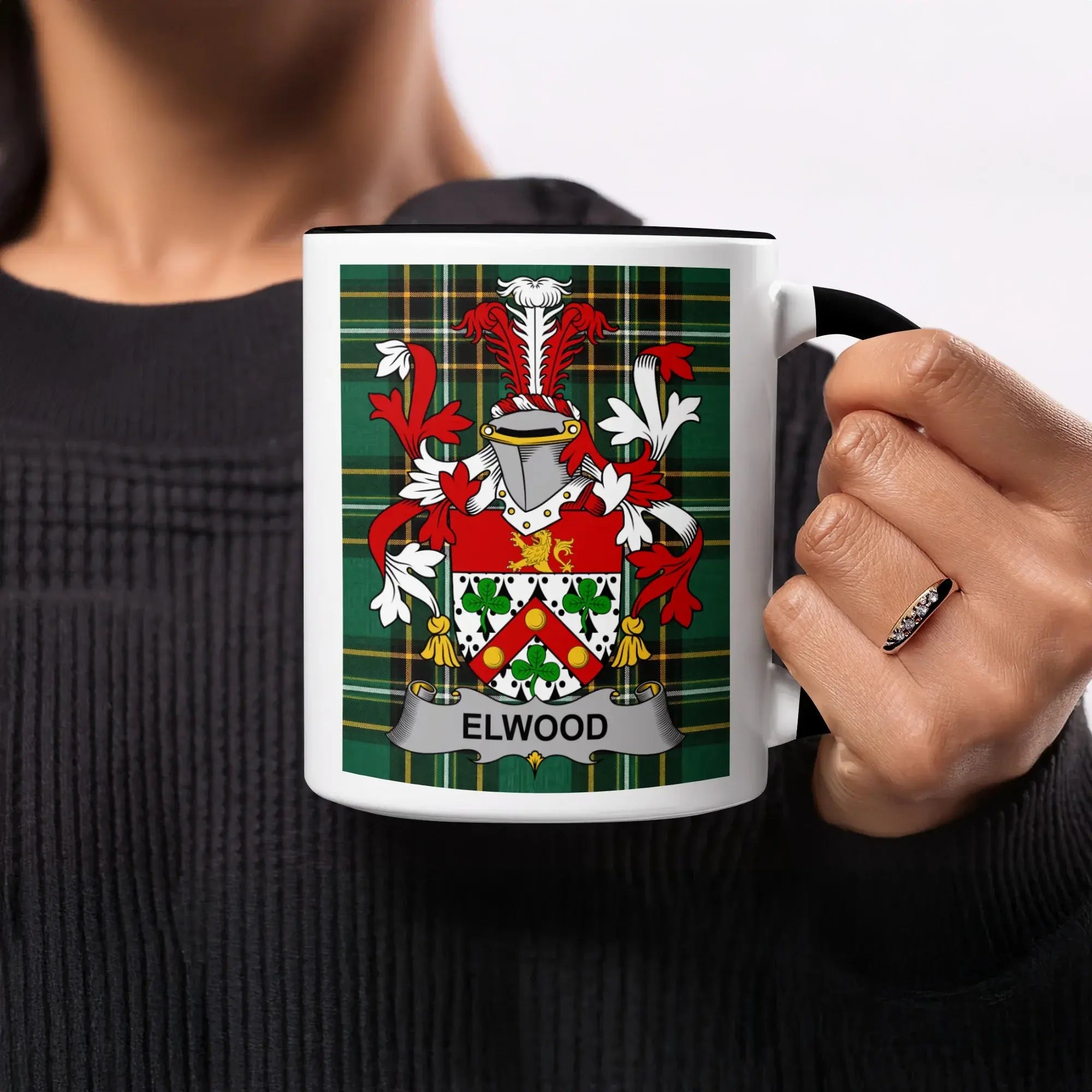 Mug with the Elwood family crest on a green tartan background.