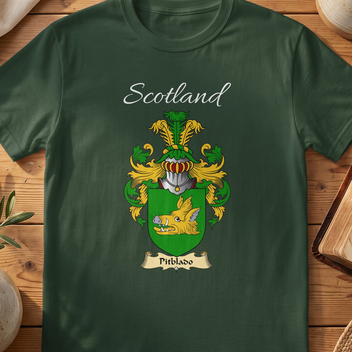 Forest Green Pitblado Scottish T-shirt laid flat with coat of arms artwork and “Scotland” text.