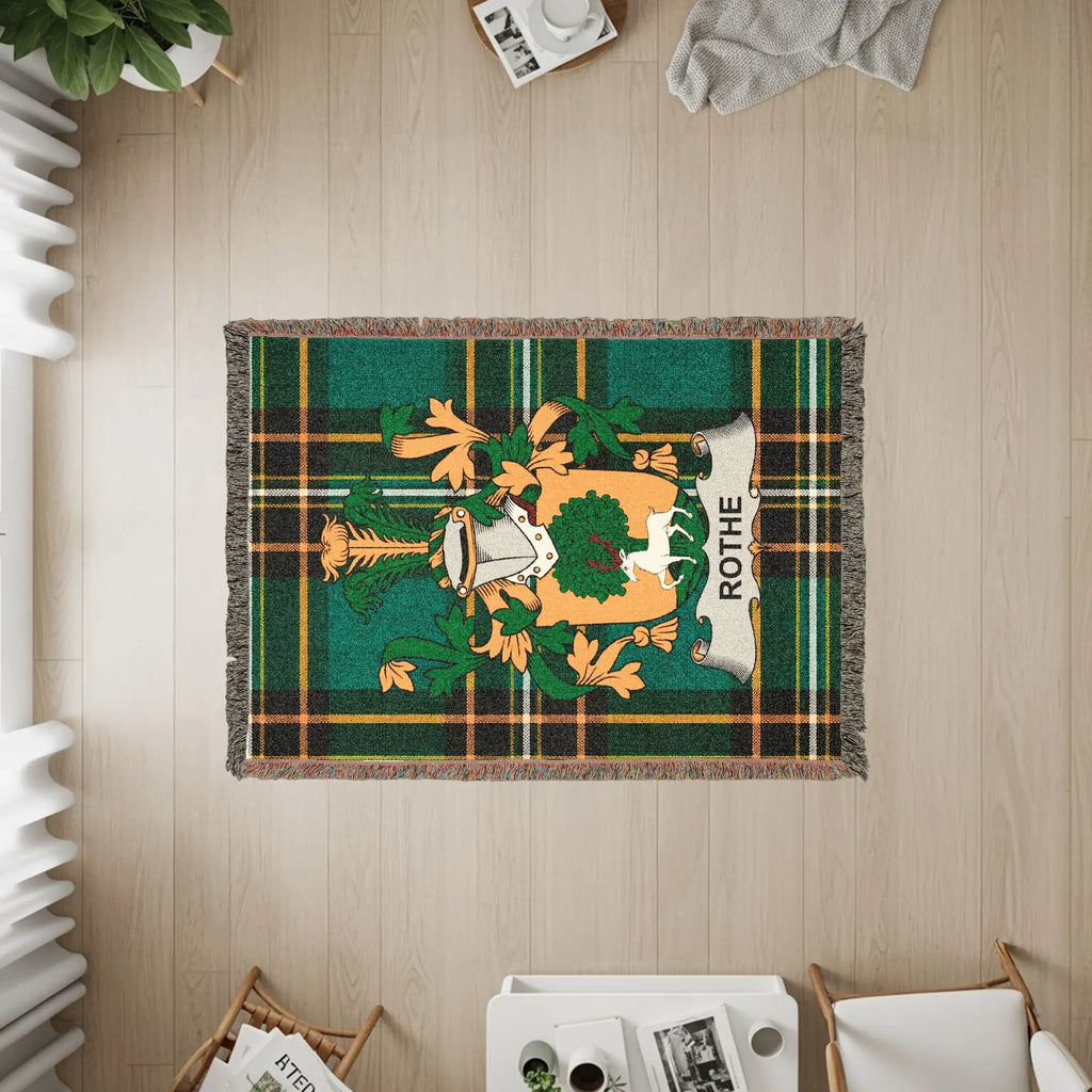 Green tartan throw blanket with Rothes clan crest.