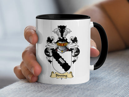 White mug with black rim featuring the Binning family crest.