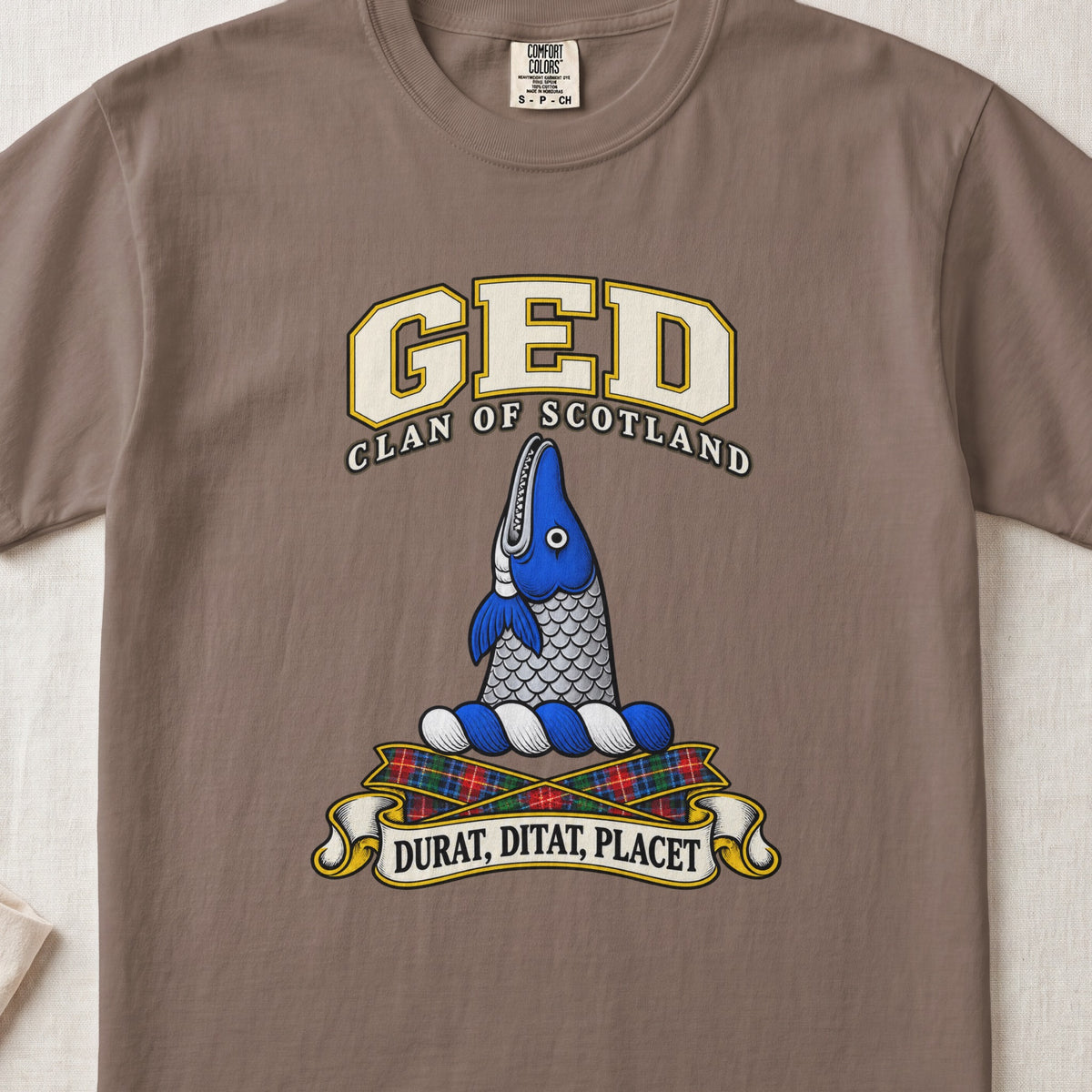 Ged Scottish clan T-shirt in Espresso, front view with an upright blue-and-silver fish and motto banner.
