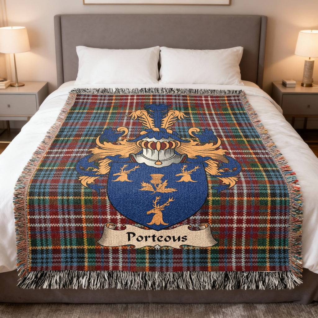 Porteous family crest emblem on a Caledonia tartan woven blanket