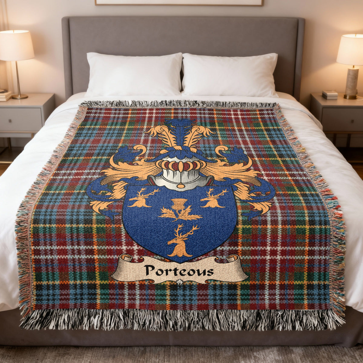 Porteous family crest emblem on a Caledonia tartan woven blanket