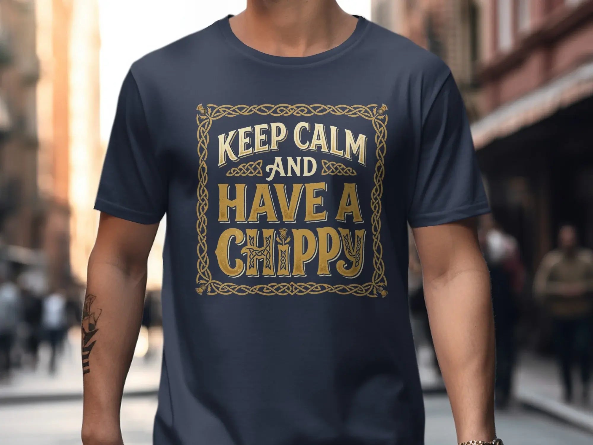 Navy t-shirt with "Keep Calm and Have a Chippy" text in gold Celtic knot border.