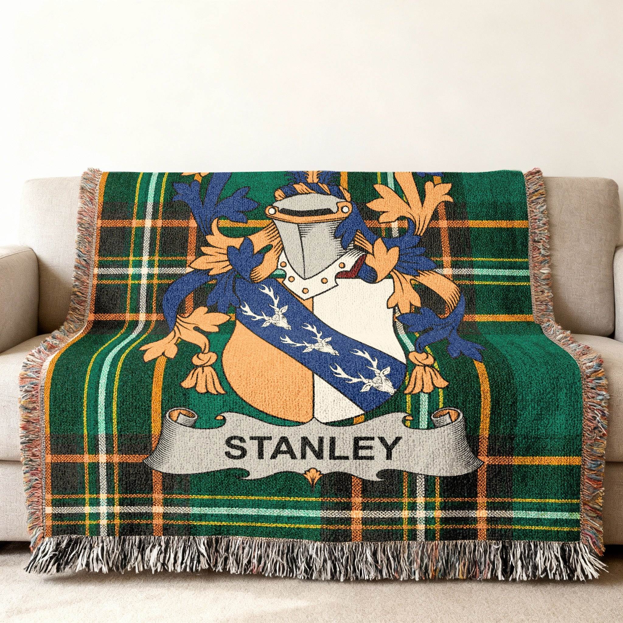 Stanley family crest on a green plaid woven throw blanket.