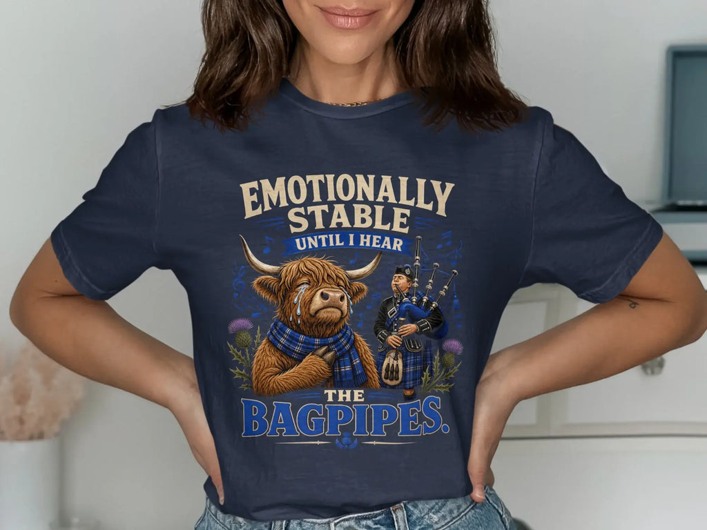 T-shirt with a Highland cow and bagpiper, text reads "Emotionally stable until I hear the bagpipes."