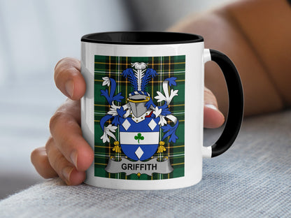 White mug with black handle featuring a blue and green plaid background and a coat of arms with the name GRIFFITH.