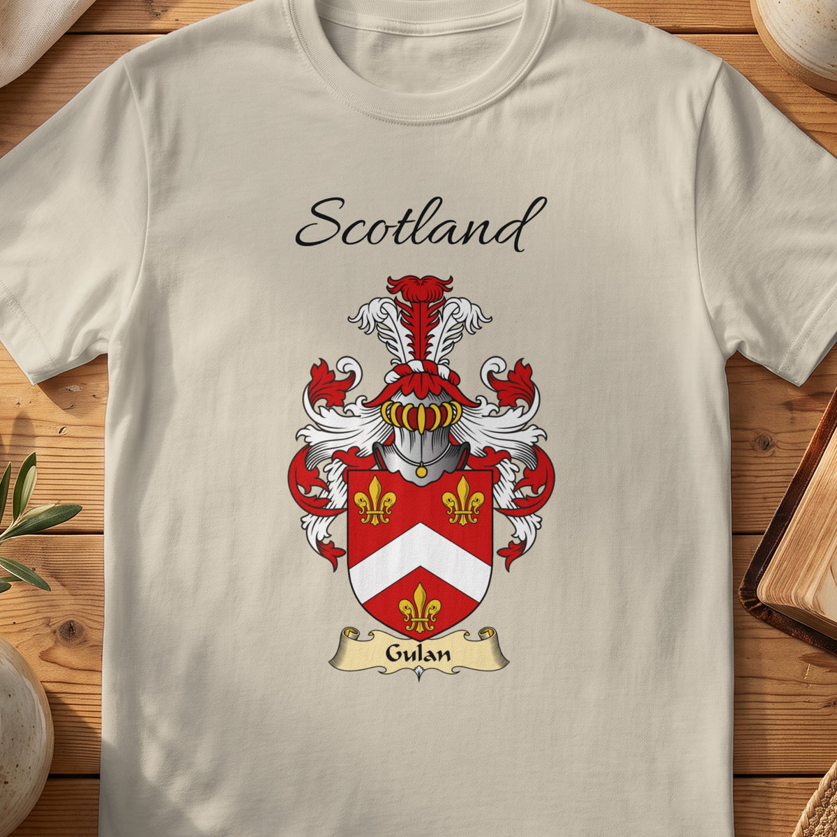 Sand Gulan Scottish family shield T-shirt featuring a white chevron and gold fleurs-de-lis on red