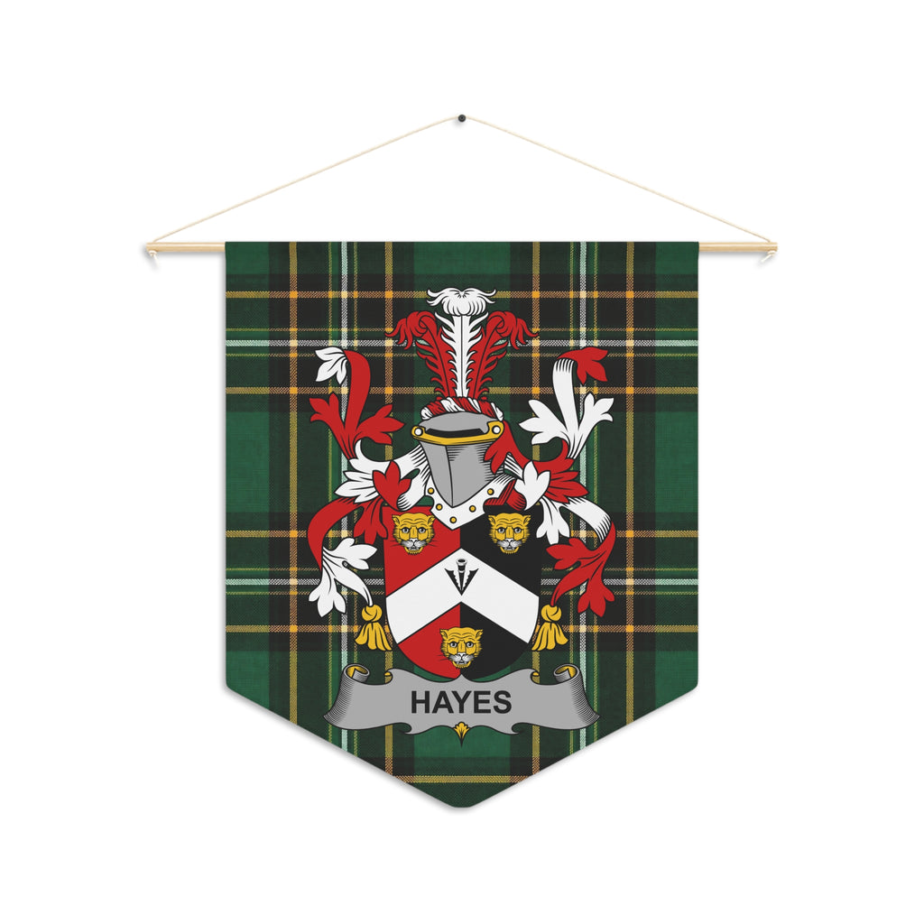 Pennant with Hayes family crest on green plaid fabric hangs from a wooden dowel.