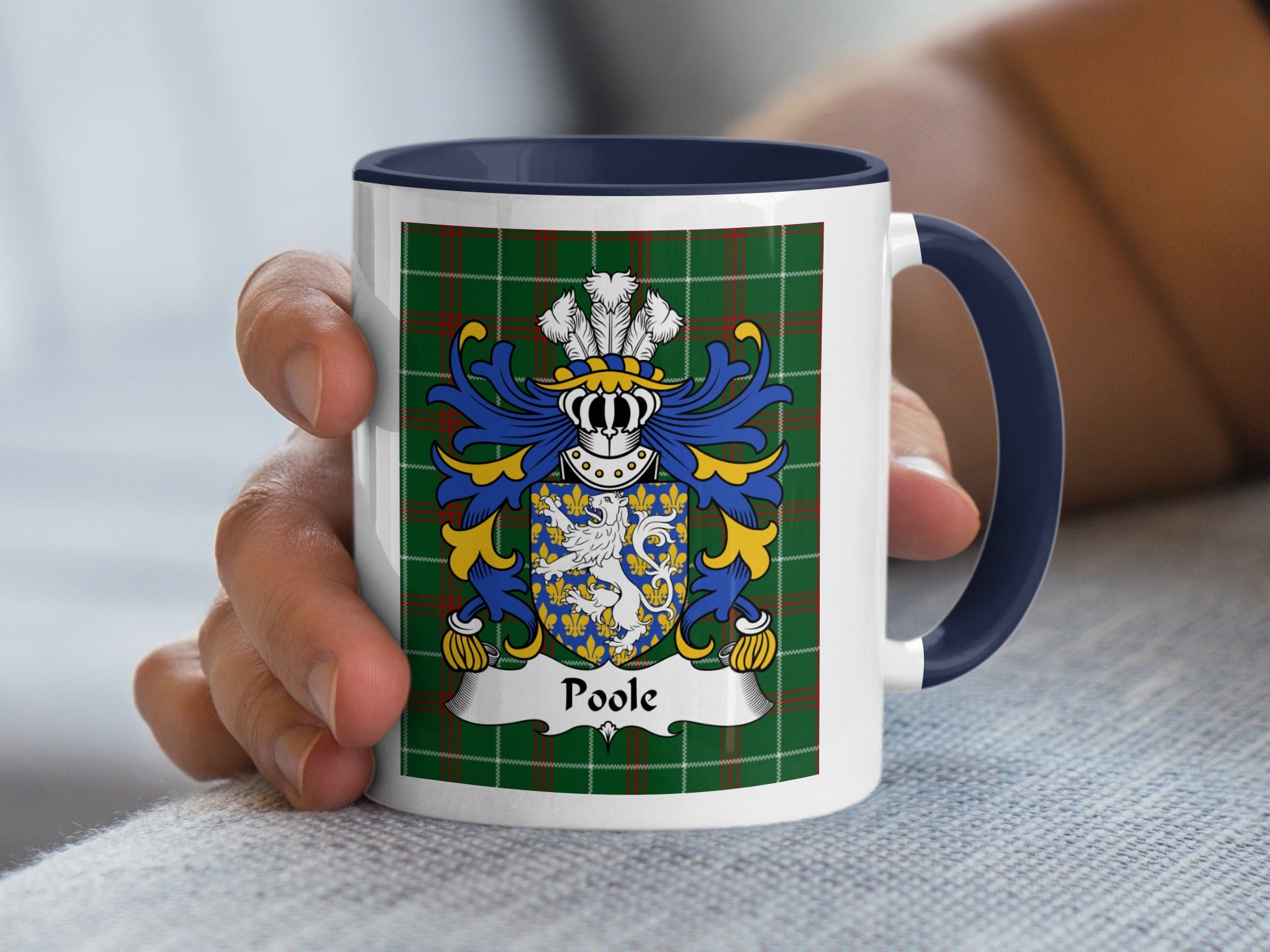 White mug with navy handle featuring the Poole family crest on a green tartan background.