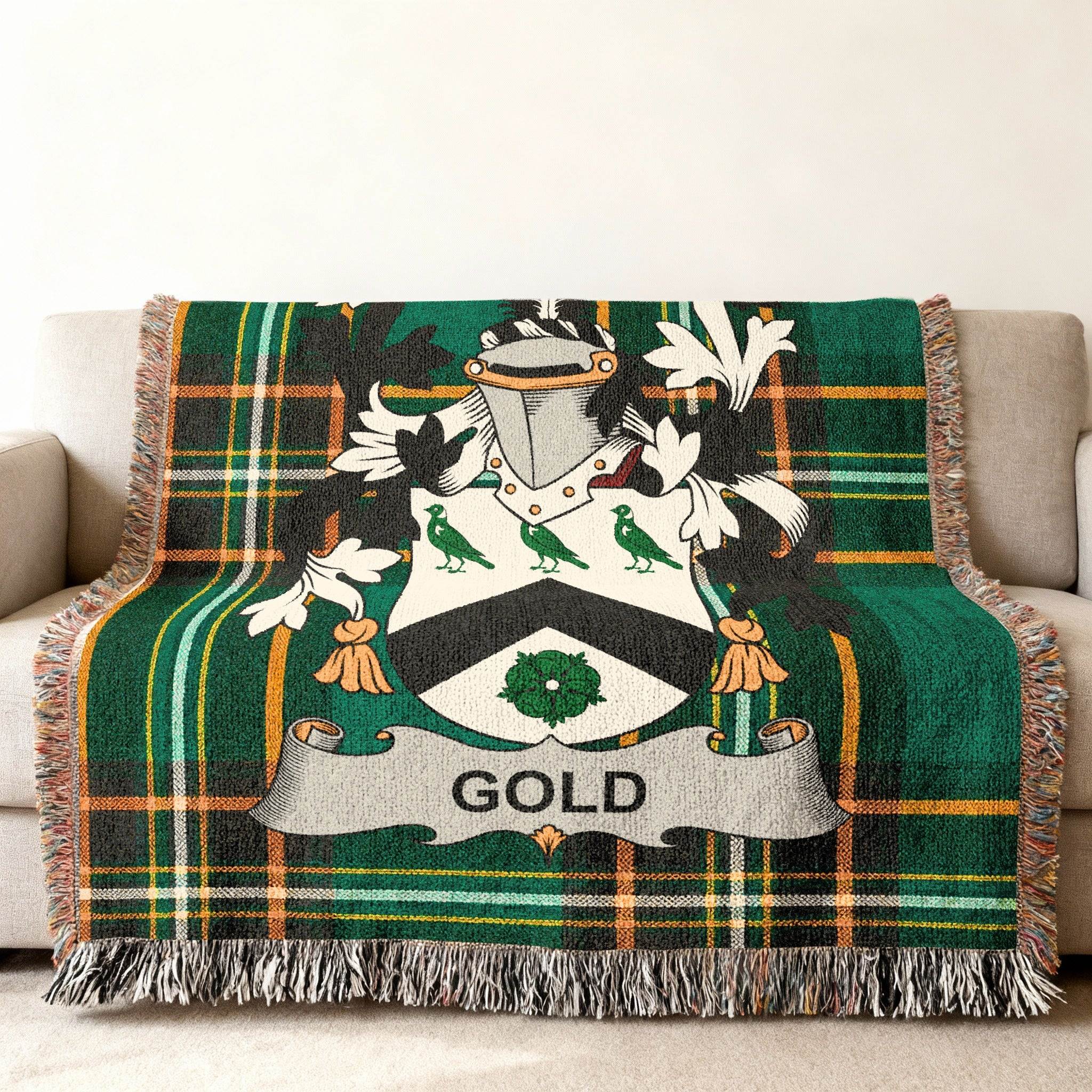 Green plaid throw blanket with Gold family crest on couch.