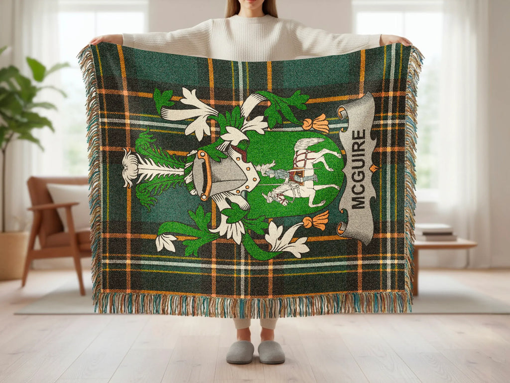 McGuire tartan blanket with crest and fringe, held by a person.