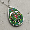 Oval pendant necklace featuring the Lyon crest on a green tartan background with Latin text.