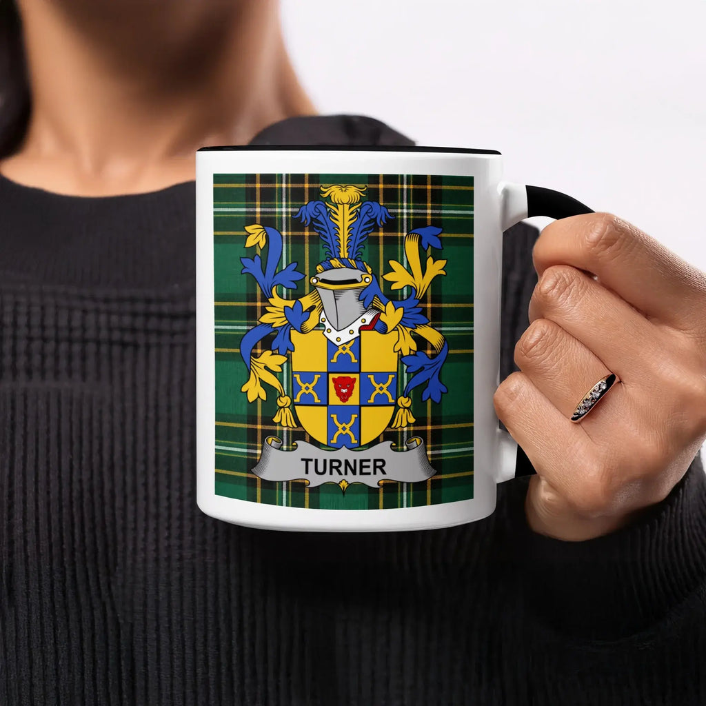 Turner coat of arms on a plaid mug held by a person.