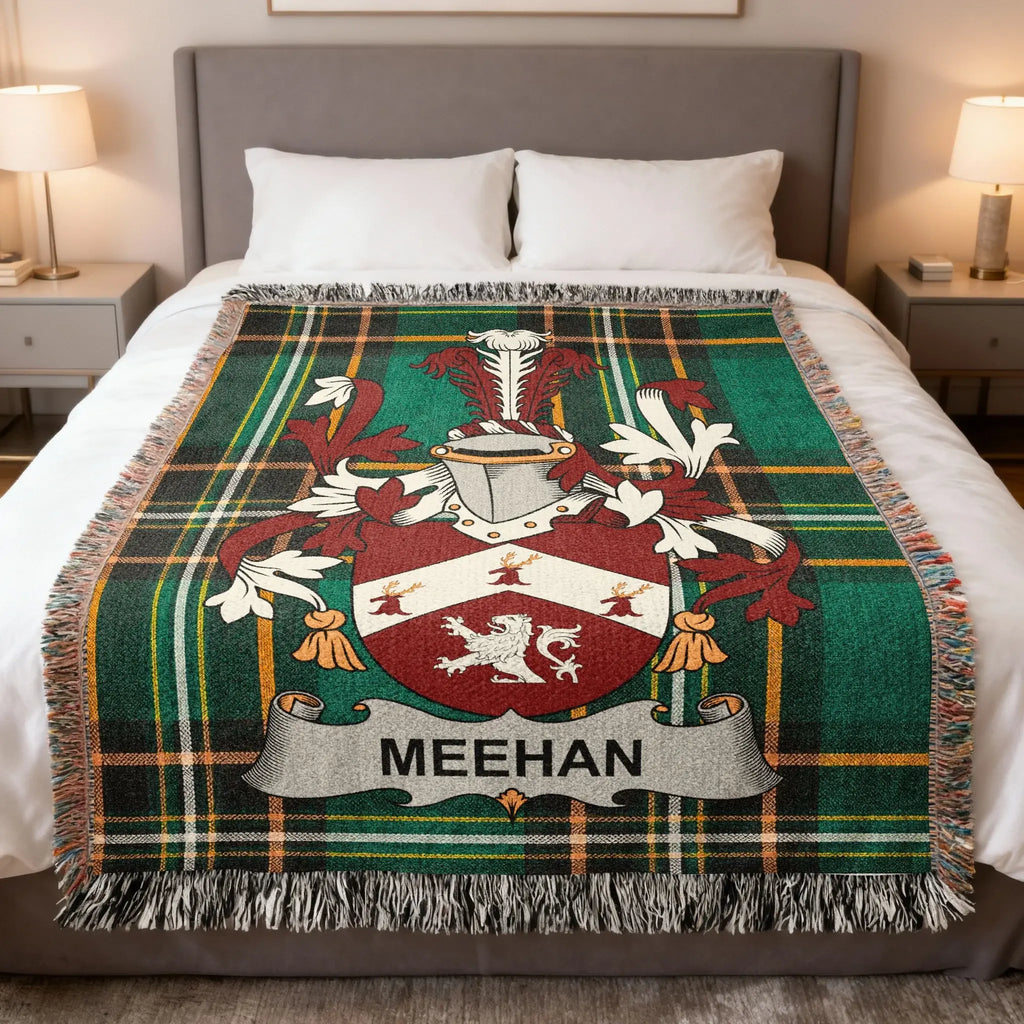 MEEHAN tartan blanket with family crest displayed on a bed.