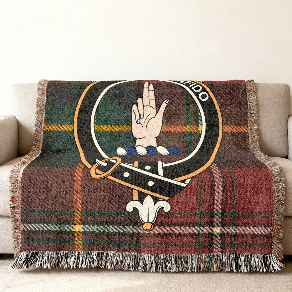 Boyd tartan woven blanket draped over armchair — fringe edge and crest detail visible