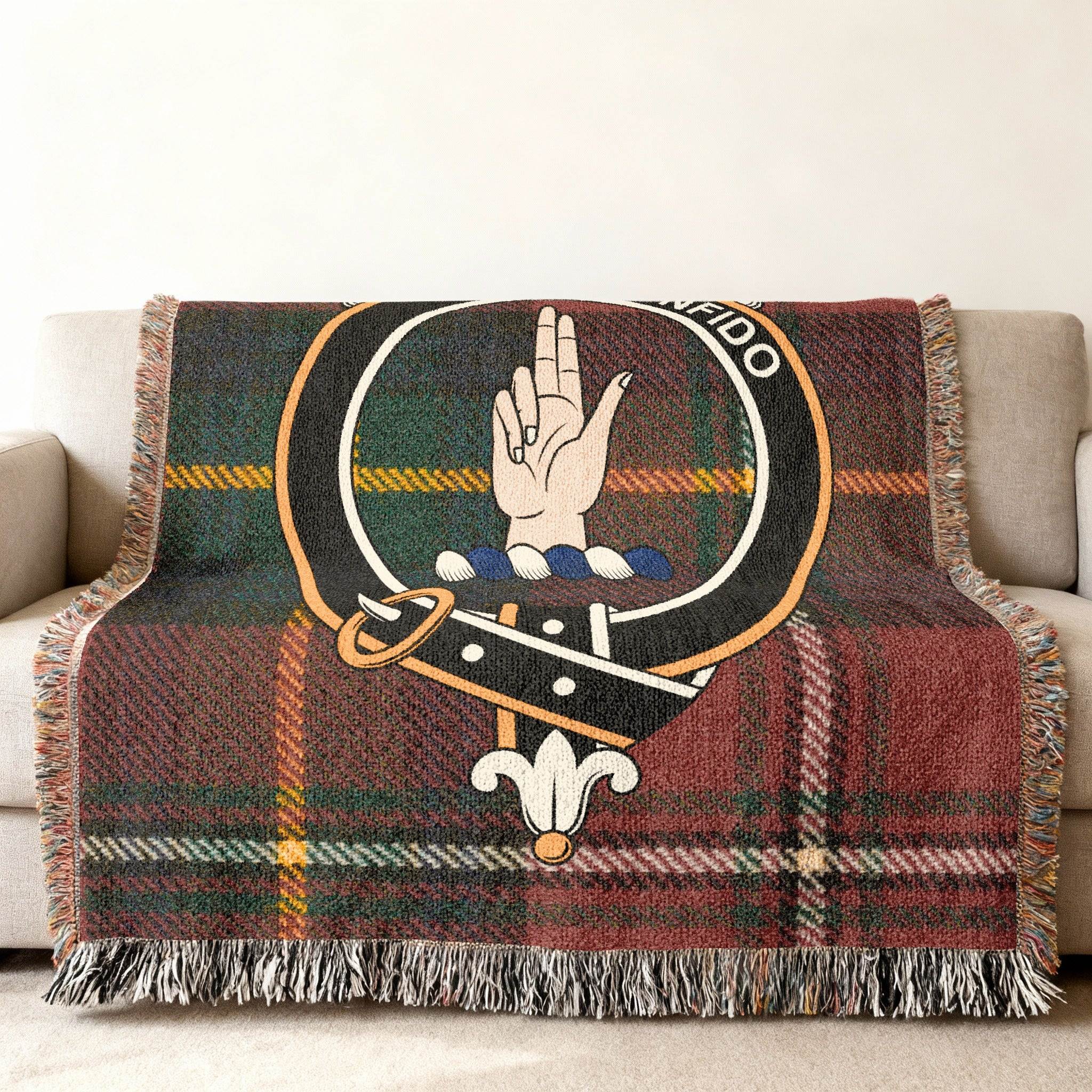 Boyd tartan woven blanket draped over armchair — fringe edge and crest detail visible