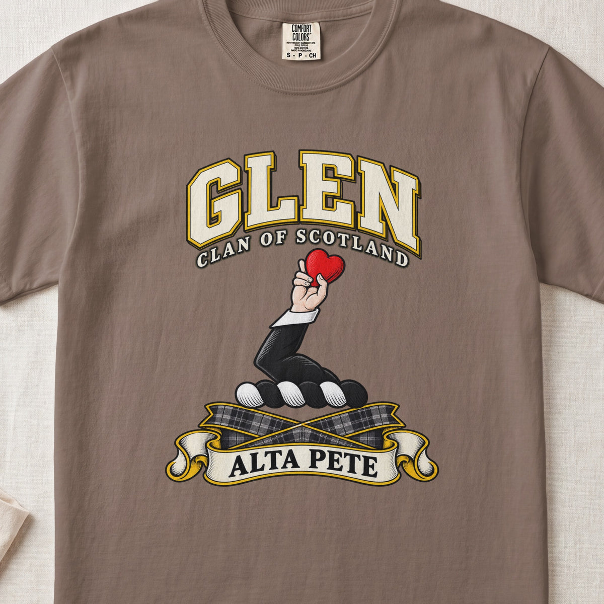 Glen Scottish clan T-shirt in Espresso, front view with a hand holding a red heart and motto banner.
