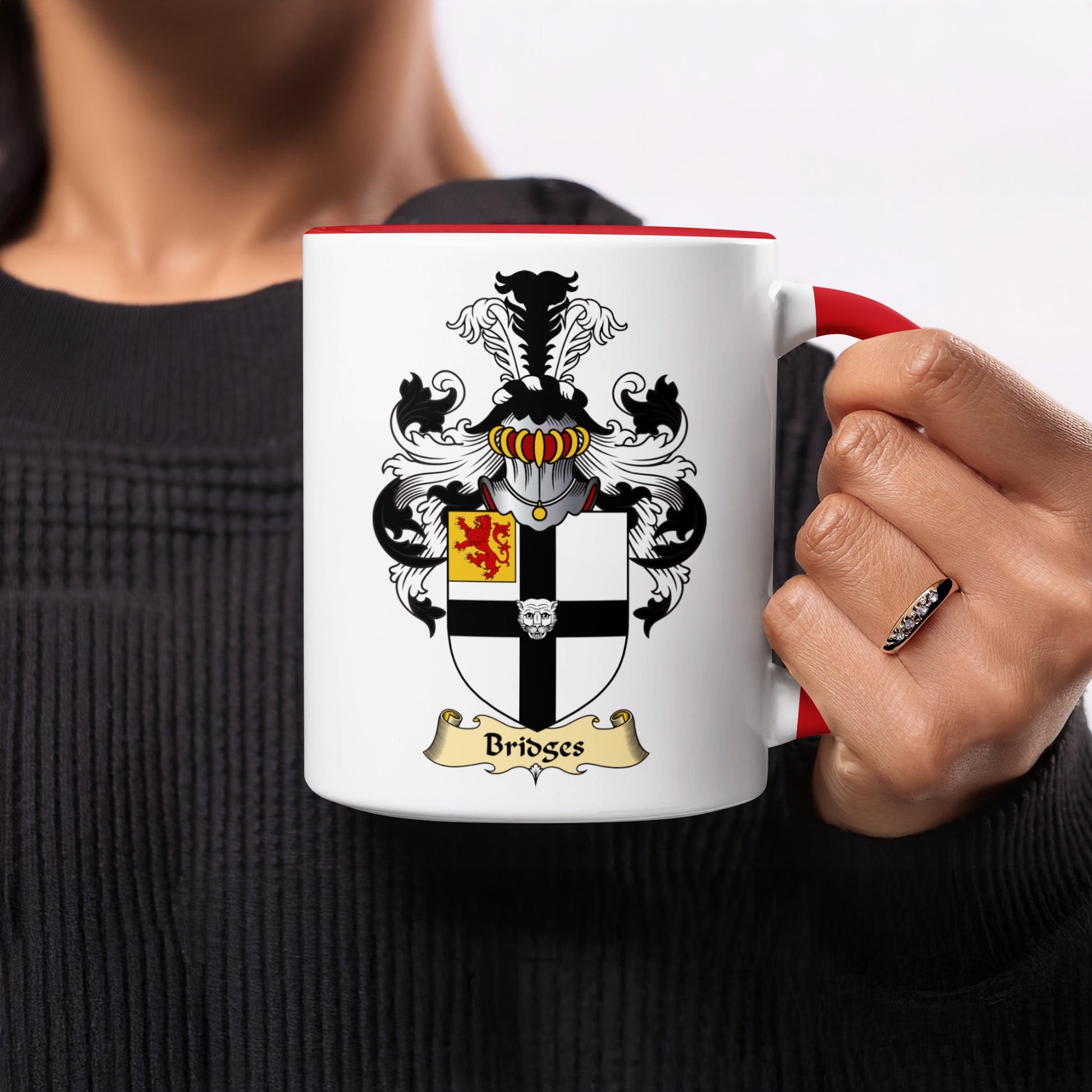 White mug with red handle displaying the Bridges family crest.