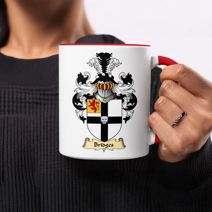 White mug with red handle displaying the Bridges family crest.