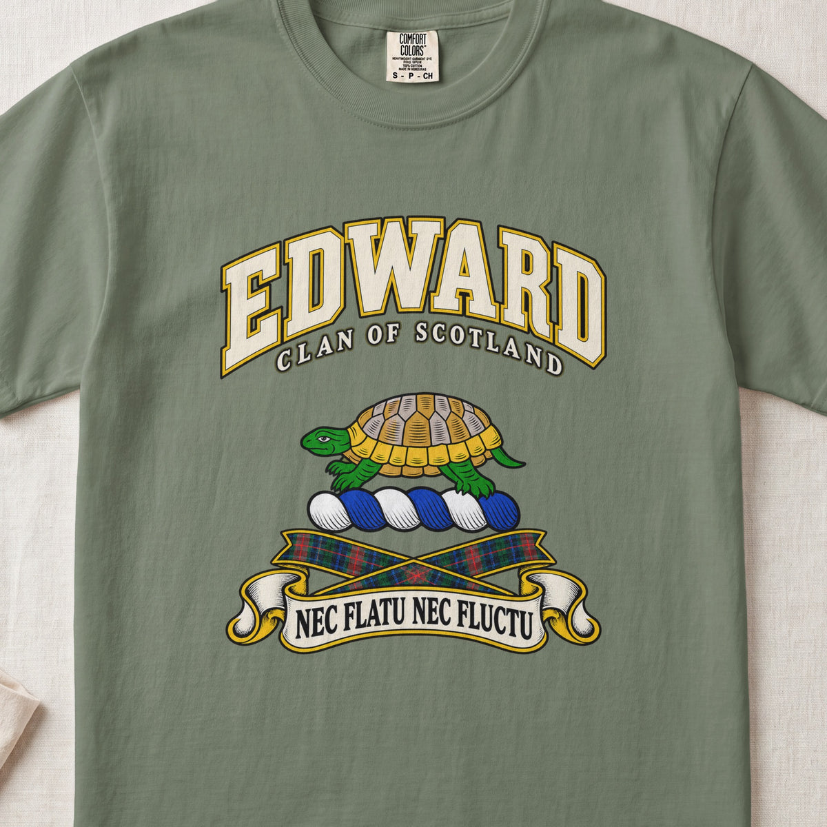 Edward Scottish clan T-shirt in Moss, front view with a green and gold tortoise and motto design.