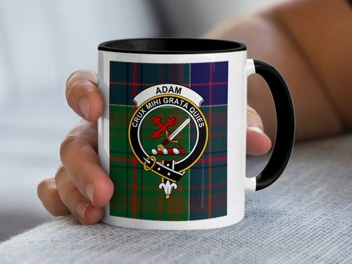 Adam Scottish family crest artwork on an 11 oz black accent mug with a tartan background