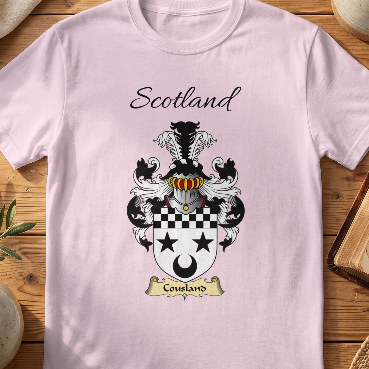 Light Pink Cousland Scottish family shield T-shirt featuring black stars and crescent below a checked top band