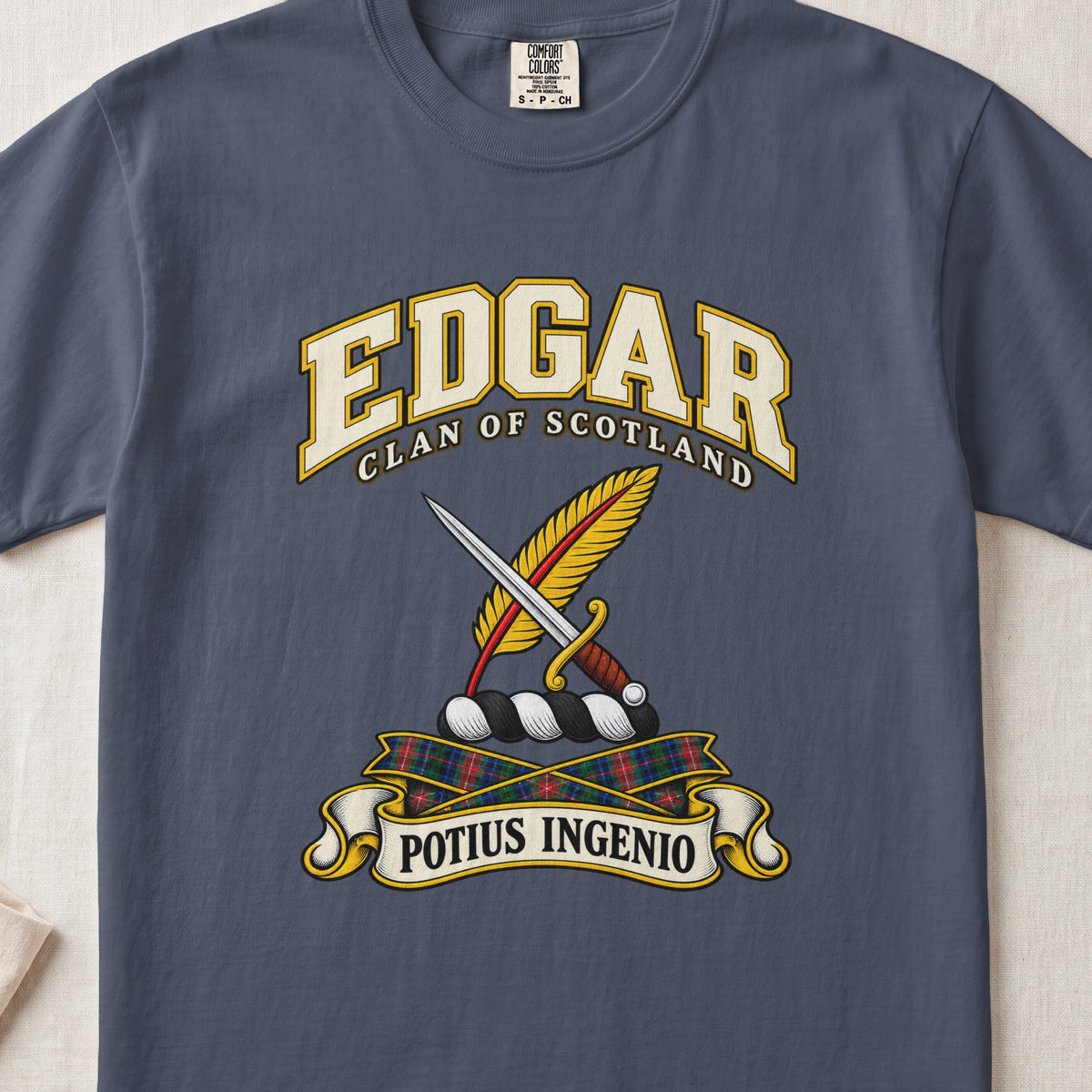 Edgar Scottish clan T-shirt in Midnight, front view with a dagger crossed with a gold feather and motto banner.