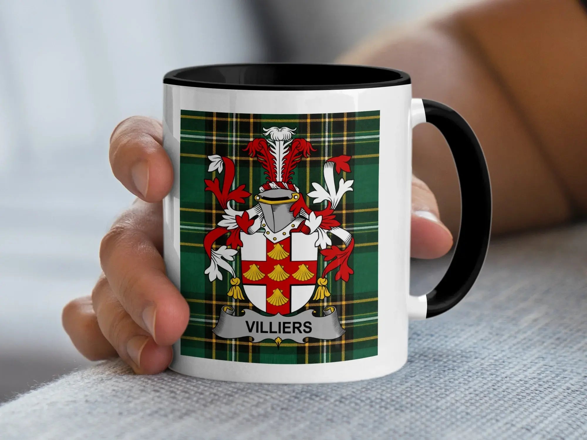 White mug with black rim featuring the Villiers family crest on a plaid background.