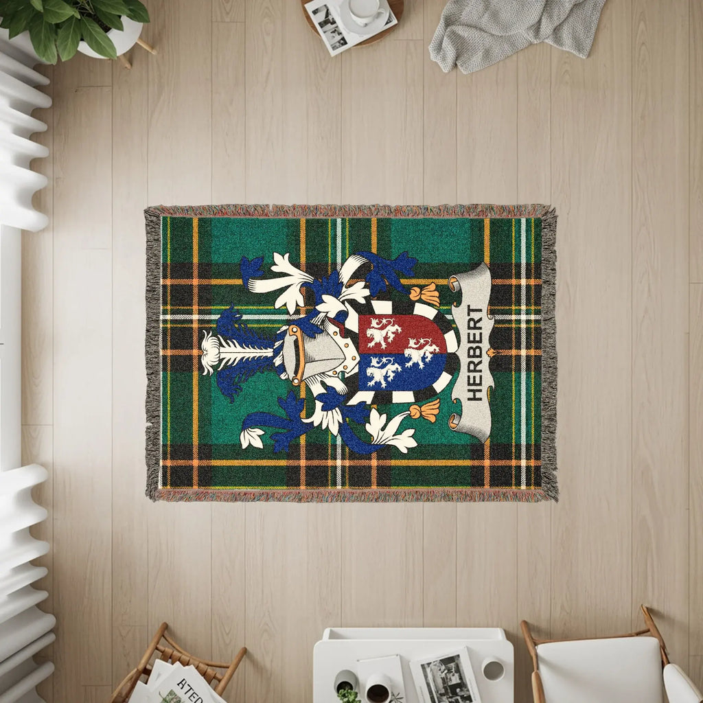 Herbert family crest displayed on a green plaid woven throw blanket.
